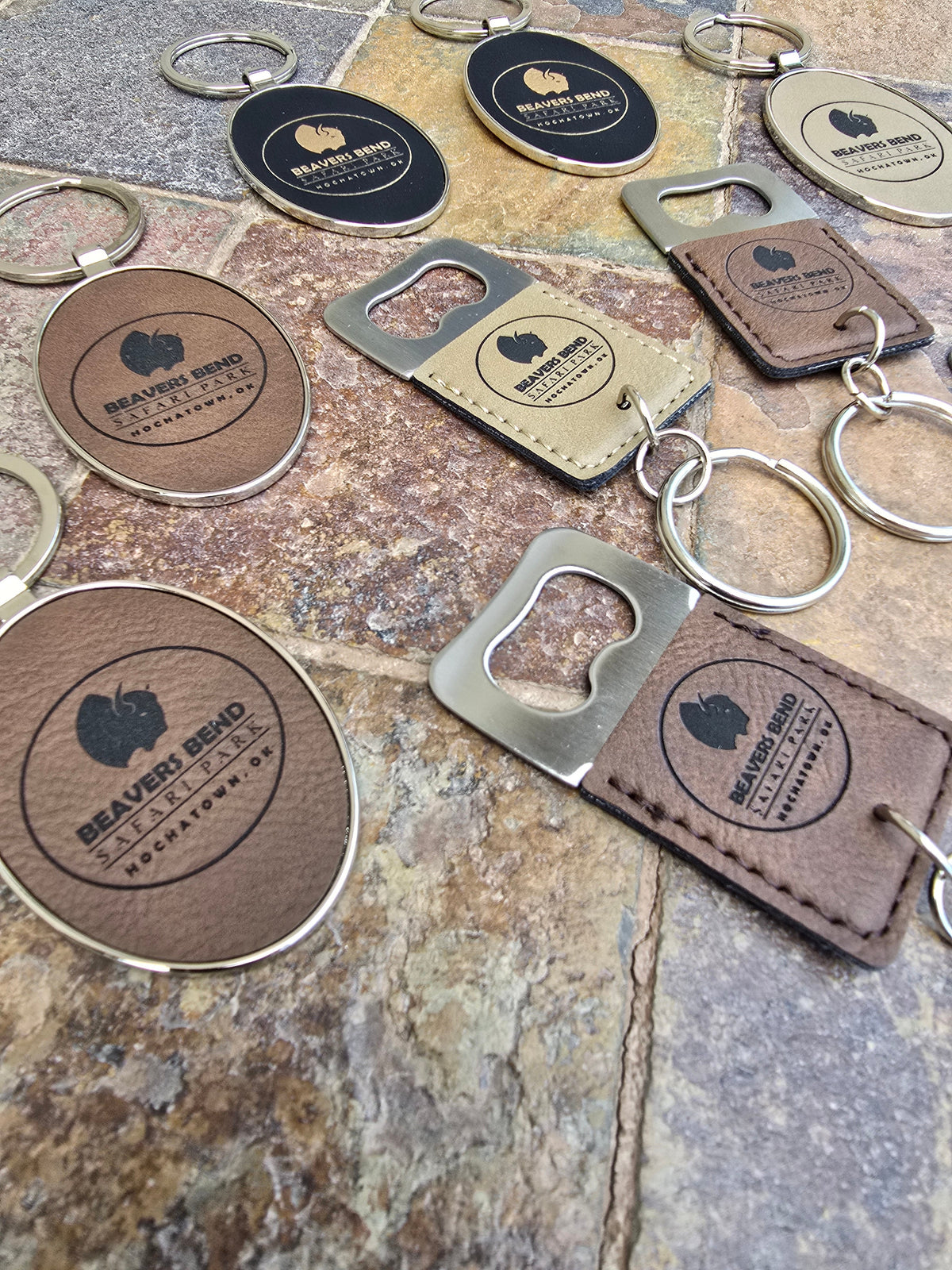 Leatherette keychains and bottle openers featuring locally inspired designs, showcasing useful and giftable souvenir merchandise visitors will be excited to take home.